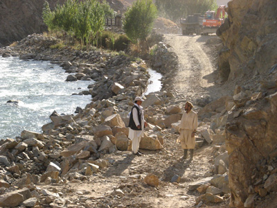 Temporary road blockage While the excavator gets a tire replace, Panjshir Valley, Afghanistan 2009