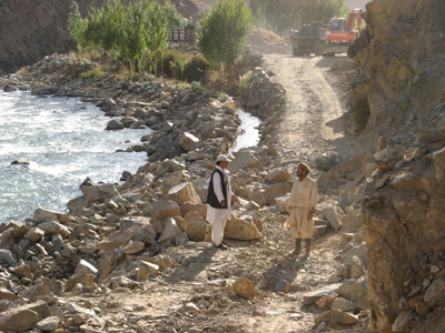 Temporary road blockage While the excavator gets a tire replace, Panjshir Valley, Afghanistan 2009