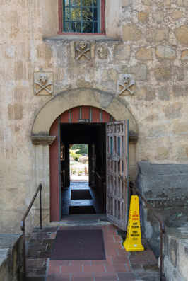 Mission entry from Churchyard Note the Skull and Crossbone moti, Mission Santa Barbara, California March 2021