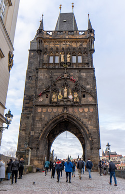14th c Tower at East end of Charles Bridge, Prague: Charles bridge, Czechia, December 2023